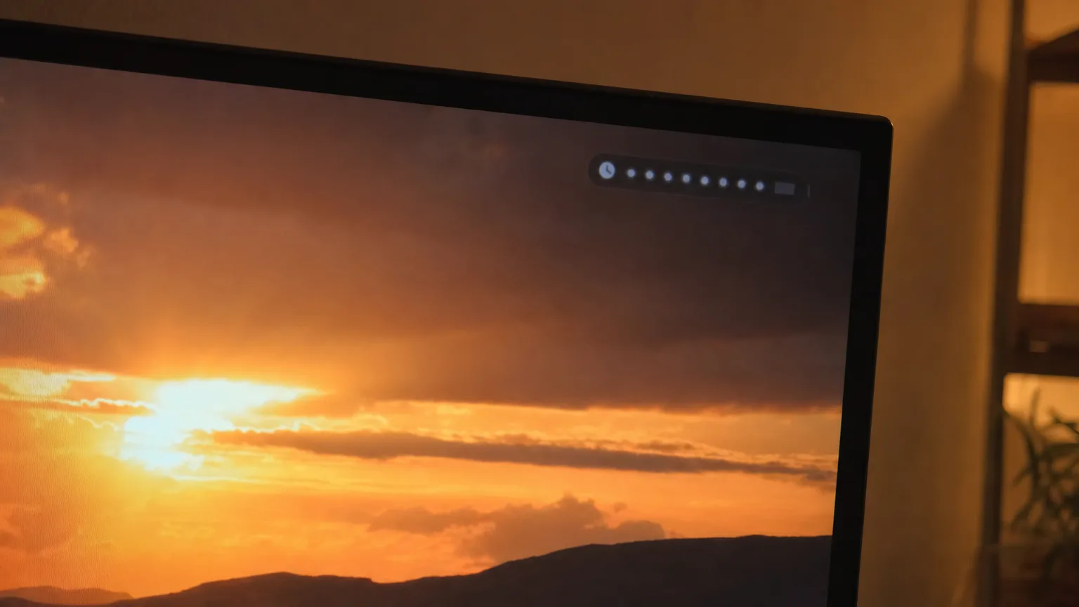 A television corner showing a bright sunset scene with the set's own status overlay visible.